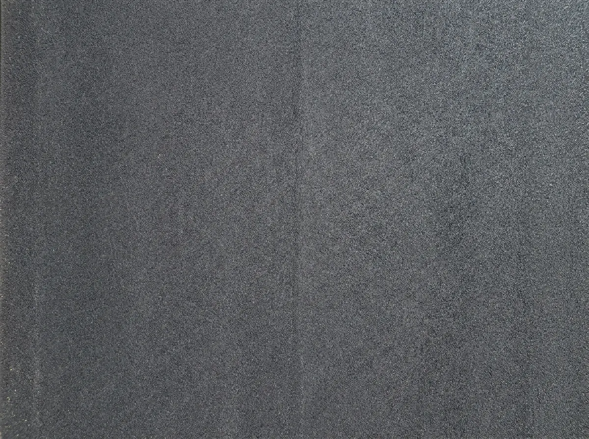 Freshly laid smooth black tarmac driveway